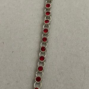 Women’s vintage Avon bracelet. Silver tone with ruby red colored gemstones